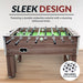 Front view of the Hathaway Driftwood foosball table on hardwood floor, showcasing its melamine driftwood finish and including a set of four 36-mm foosballs.