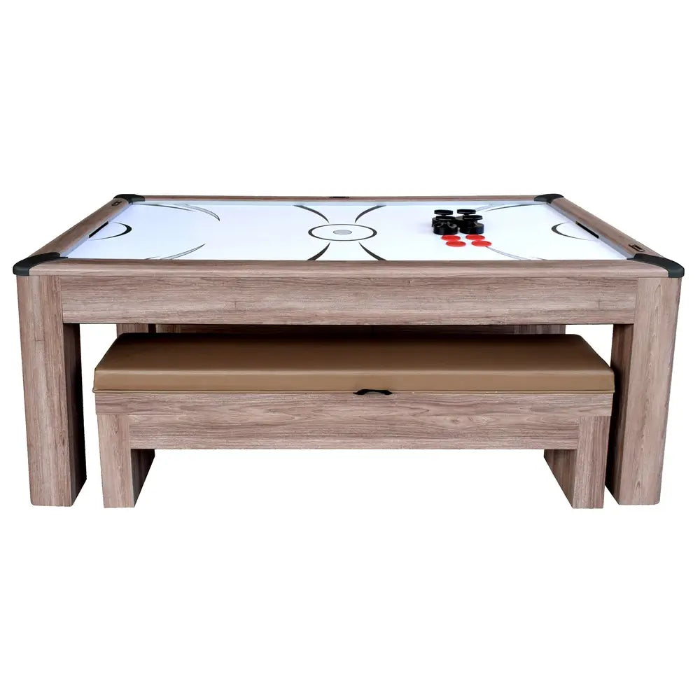 Front view of modern air hockey table with playfield graphics, four strikers, and four pucks, benches stored neatly underneath.
