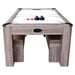 Air hockey tabletop with built-in goals and arcade-style markings, tan cushioned benches tucked underneath for space-saving design.