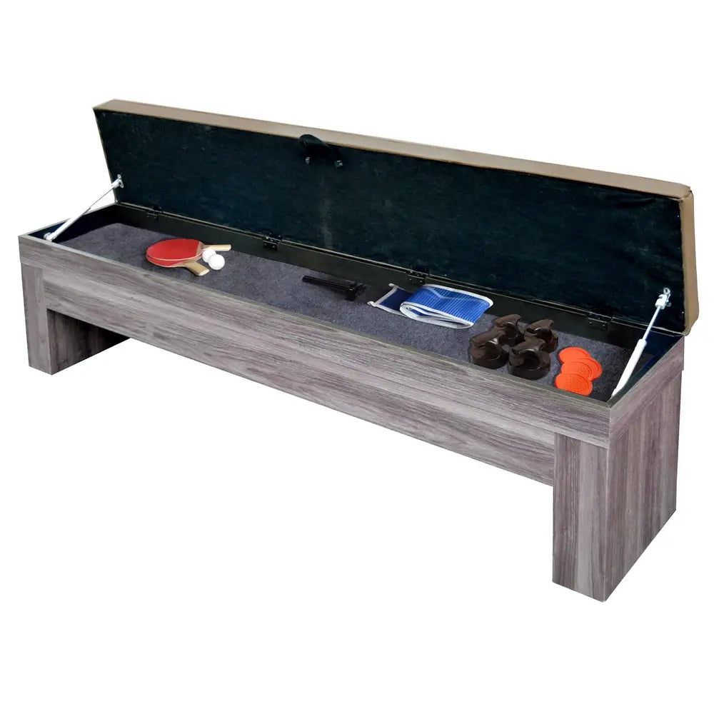Storage bench with open cushioned lid, revealing organized space for air hockey, ping pong, and table tennis accessories including paddles and pucks.