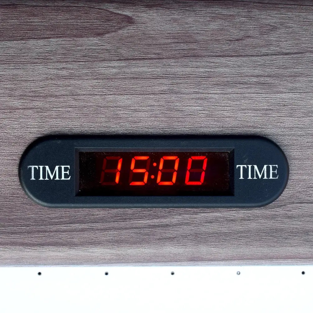 Digital game timer with red LED display embedded in wood grain table, showing 15-minute countdown for game sessions.