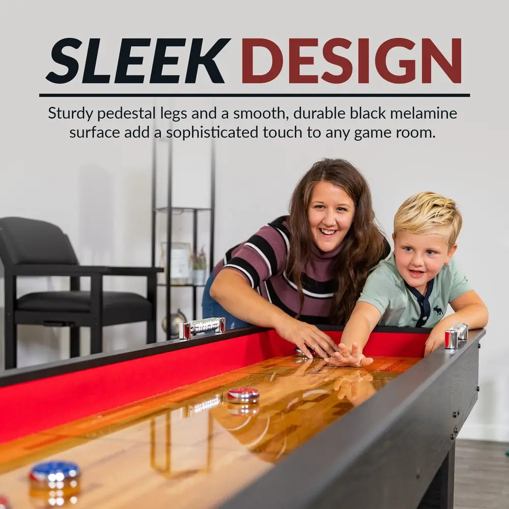 Mother and child playing on a Hathaway black shuffleboard table with smooth poly-coated surface and red padded interior.