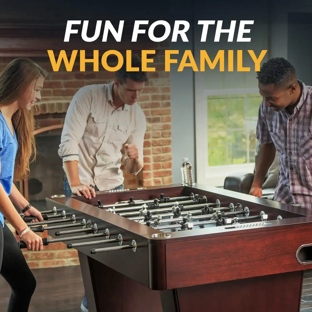 Group of three people playing on a premium foosball table in a stylish home, showcasing the product’s family-friendly design and entertainment value.