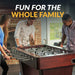 Group of three people playing on a premium foosball table in a stylish home, showcasing the product’s family-friendly design and entertainment value.