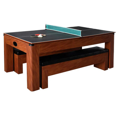 3-in-1 Hathaway game table in table tennis mode with net, paddles, and balls set on black surface; features cherry wood finish and matching storage bench seating.