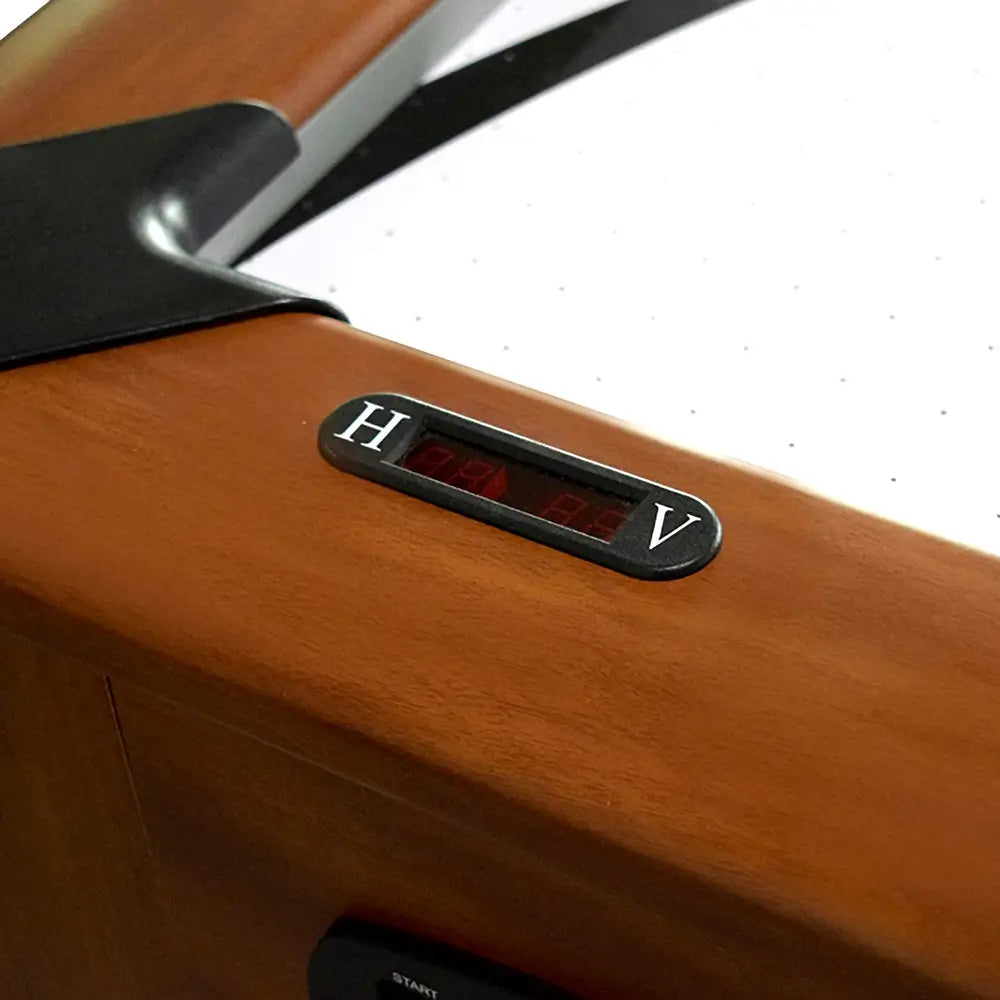 Digital scoreboard on air hockey table rail with LED display and H/V indicators for home and visitor team scores, set in cherry wood frame.
