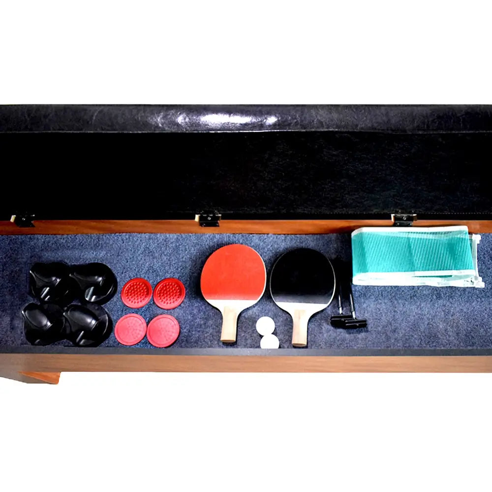 Open storage bench interior with organized accessories including air hockey strikers and pucks, table tennis paddles, balls, net, and clamps.