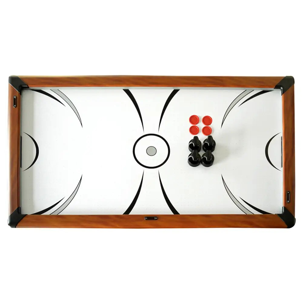 Top-down view of air hockey playfield with wood grain frame, showing four black strikers and four red pucks arranged in center.