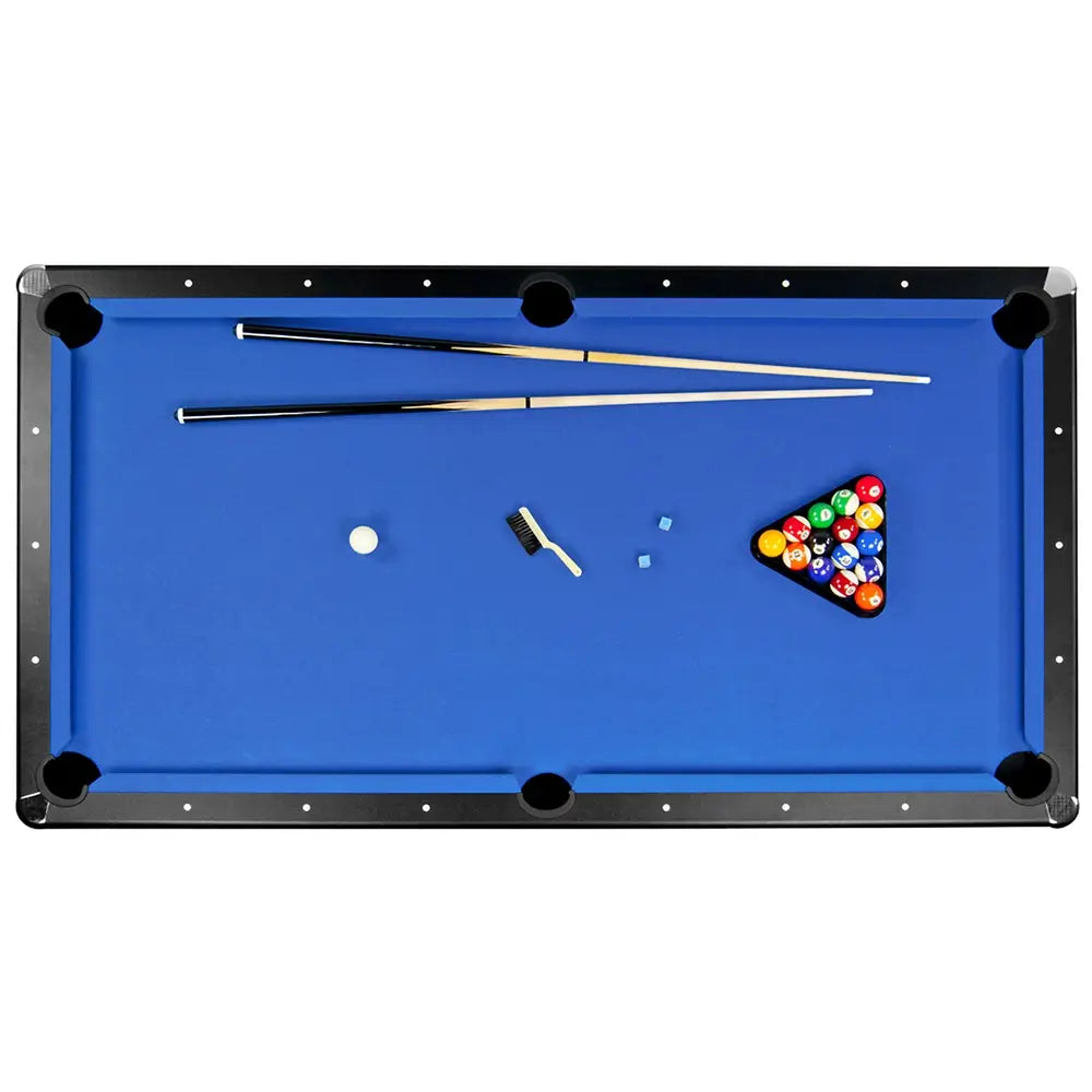 Top-down view of Hathaway Hustler 7-foot pool table with bright blue felt, two pool cues, triangle rack with billiard balls, cue chalk, table brush, and cue ball included on the playing surface.