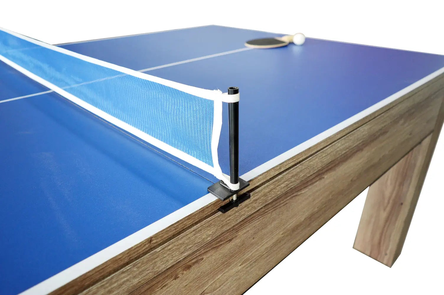 Close-up of billiard accessories including pool cues, racked balls, and a brush on the red felt of a Hathaway table.