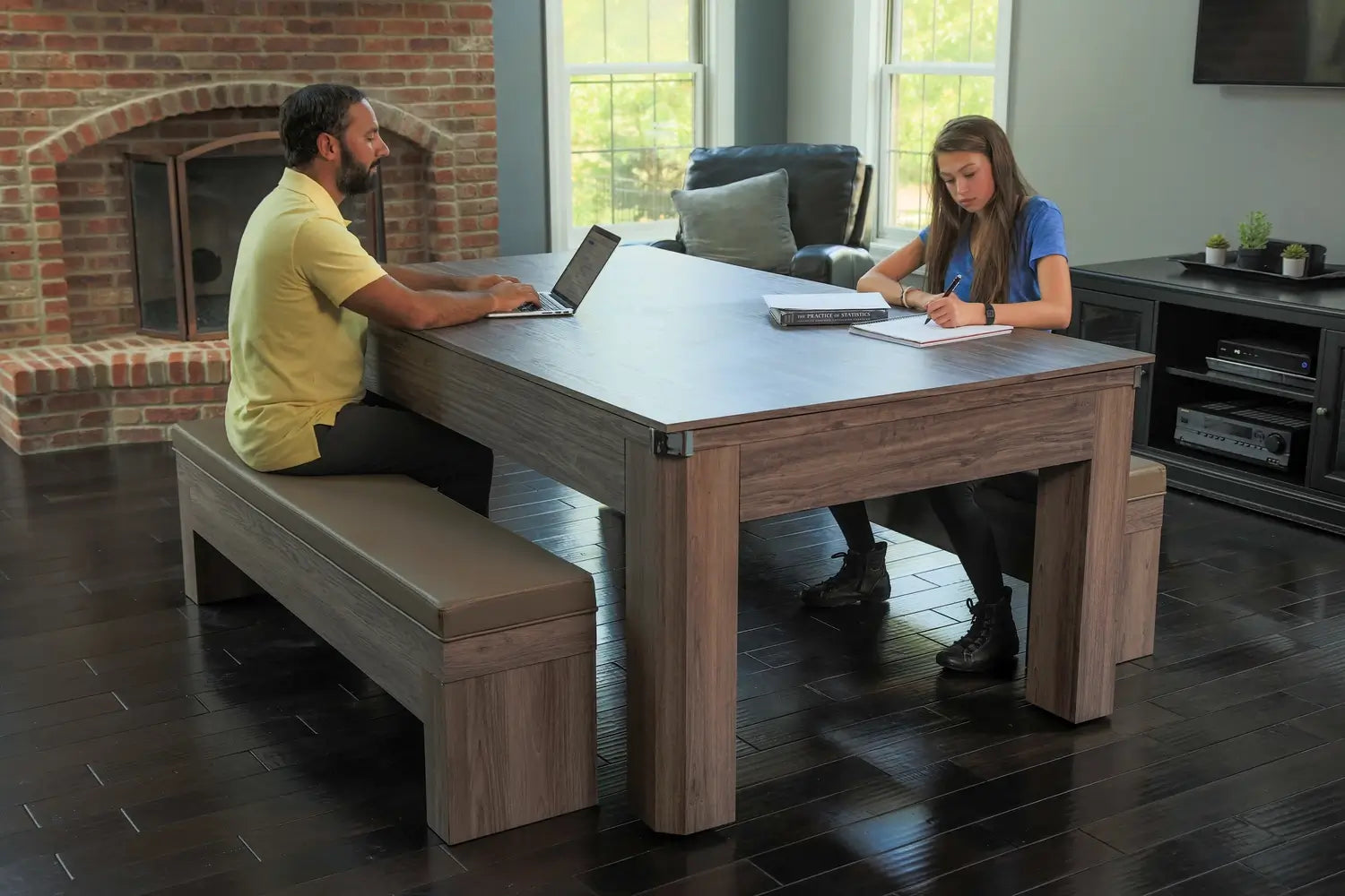 Lifestyle scene of a man on a laptop and a woman studying at the Hathaway Newport 7-ft combo table configured as a multi-functional driftwood dining and work table.