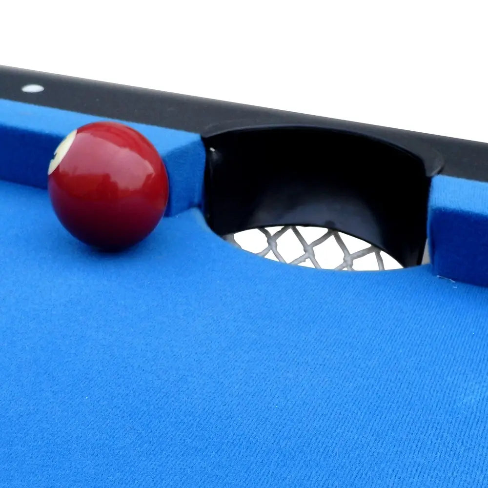 Close-up of Hathaway Fairmont 6-ft Pool Table pocket with blue felt surface and mesh drop pocket, showing a red ball near the hole.