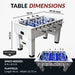 Infographic showing foosball table dimensions (55 x 29.25 x 34.5 in) and playfield size (46 x 26.75 in), recommending 8 x 8.5 ft space for setup.
