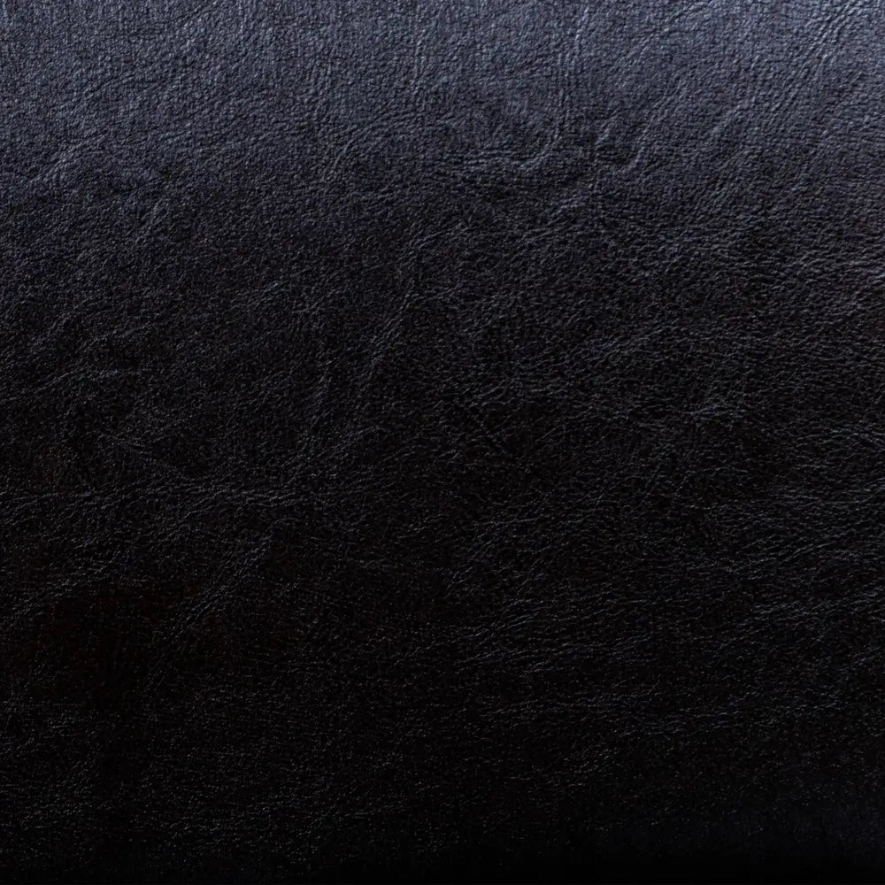 Textured close-up of Hathaway chair’s black faux leather upholstery, designed for comfort, durability, and easy cleaning.