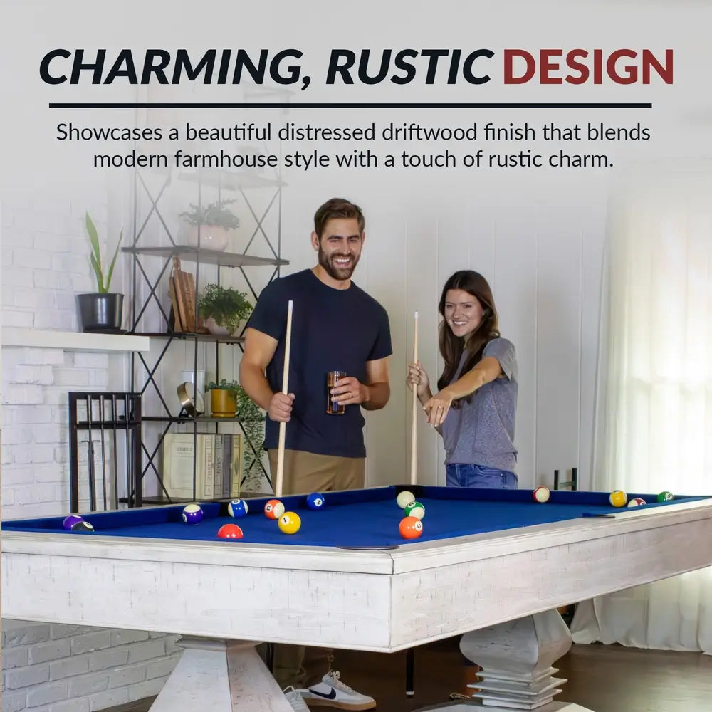 Couple playing on the Hathaway Montecito pool table with driftwood finish and navy blue felt in a cozy modern farmhouse game room setting