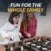 Mother and daughter smiling while playing on the Hathaway Excalibur foosball table, promoting fun for the whole family in a modern home setting.