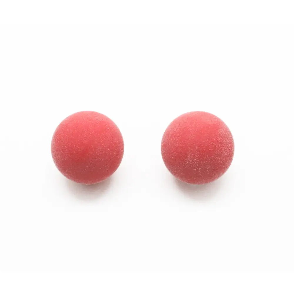 Pair of red textured foosball balls designed for smooth, controlled gameplay on standard or professional foosball tables.