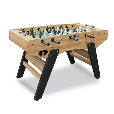 Angled side view of light oak foosball table with black A-frame legs, dual ball return holes, and ergonomic black rods.