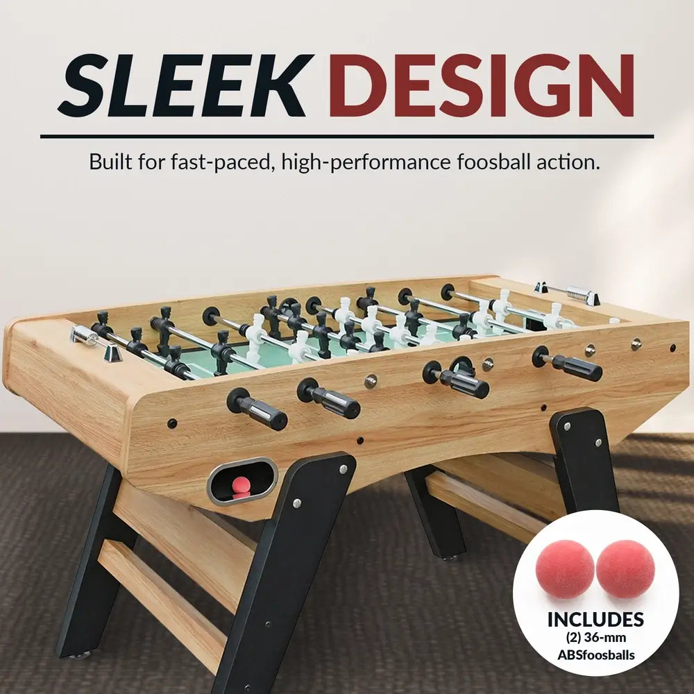 Light oak foosball table with black ladder-style legs and red ball in return slot; features sleek, modern design and includes two 36mm ABS foosballs for fast-paced gameplay.