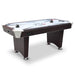 Modern air hockey table with dark cherry wood cabinet and chrome accents, featuring a white playfield with starburst graphics, two black pushers, two red pucks, and electronic controls on the side panel. Sturdy pedestal-style legs with chrome leg levelers enhance balance and stability.