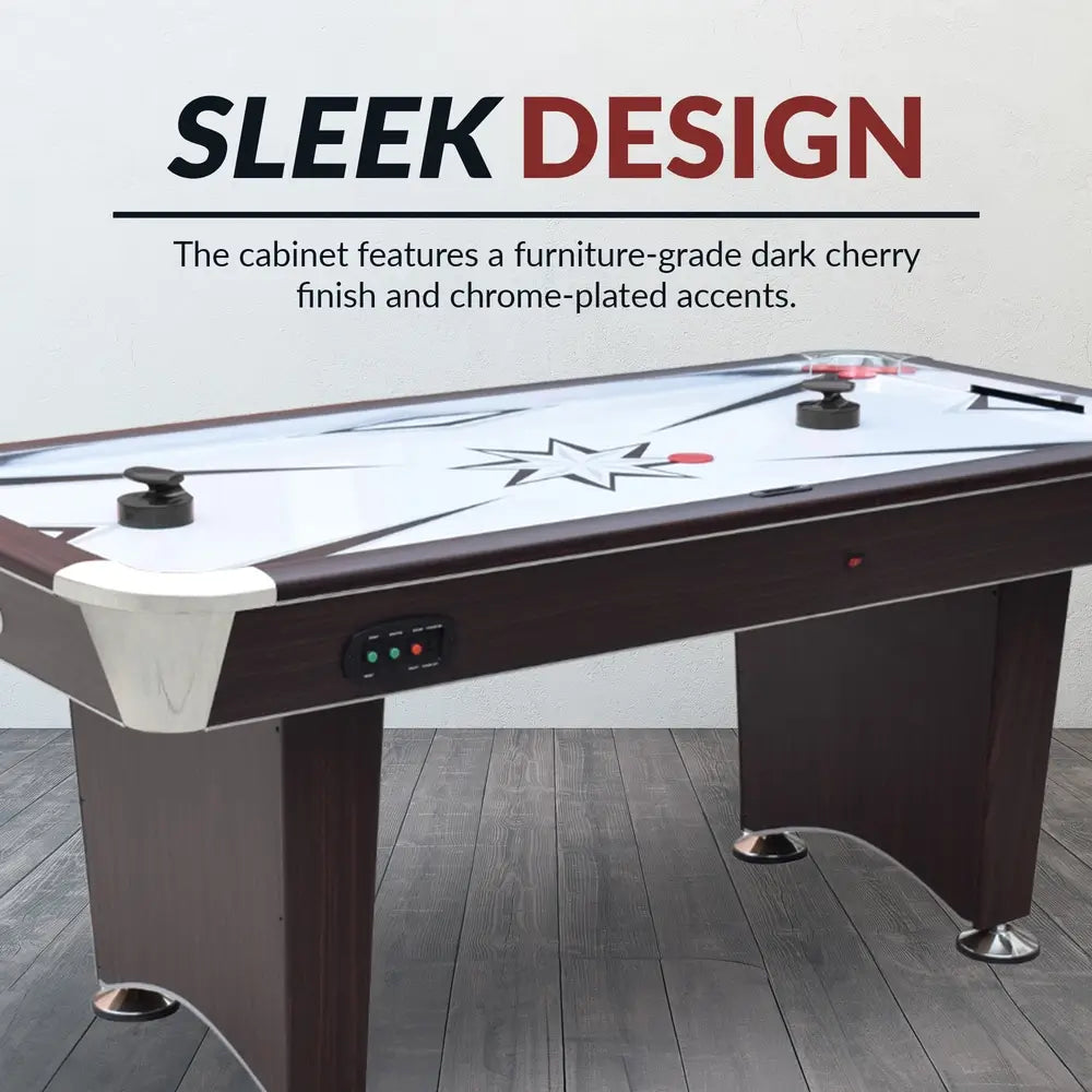 Sleek air hockey table with furniture-grade dark cherry wood finish, chrome accents, and starburst playfield design. Includes two black ergonomic pushers, red pucks, digital control panel, and arched pedestal-style legs with leveling feet. Text overlay: “SLEEK DESIGN.”