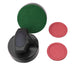 Close-up of ergonomic black air hockey striker with green felt-lined base and two red pucks placed on a white background. Designed for smooth glide and accurate control during gameplay.