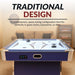 Front-facing view of Hathaway Phantom II air hockey table in blue, with chrome accents, white graphic playfield, and a contemporary design. Shown in a cozy game room with couch and bookshelf, emphasizing space-saving traditional design.