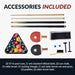 Flat lay of included Hathaway game table accessories—two 57-inch cue sticks, full set of billiard balls, two cue chalks, table brush, racking triangle, ping pong net, two paddles, and two table tennis balls.