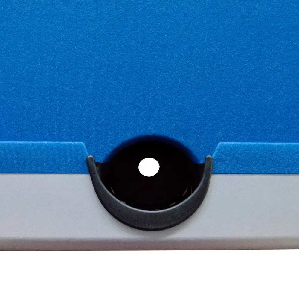 Close-up of side pocket on blue felt Hathaway pool table, showcasing black drop pocket design integrated into silver rail for billiard ball capture.