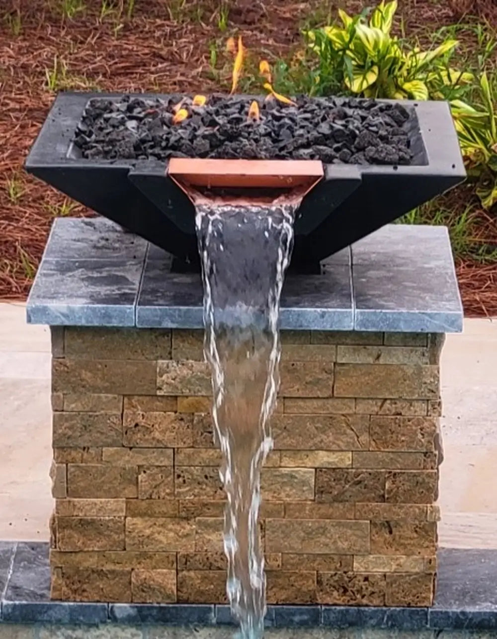 Black Travertine TessaRai Square Fire/Water Bowl Kit with copper spillway and waterfall mounted on stone pool column
