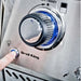 Close-up of the Broil King Imperial S200 control panel with a blue LED-backlit knob and a finger pressing the electronic ignition button.