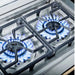 Close-up of the Broil King Imperial S200 double side burner's slide-out stainless steel grease drip tray for easy cleaning.
