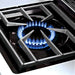 Close-up of a high-output professional gas side burner with blue flames on a Broil King Imperial series outdoor kitchen.