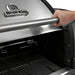 Close-up of the Broil King Imperial S-690i 6-burner gas grill lid being opened, showing the stainless steel handle and integrated hood thermometer.