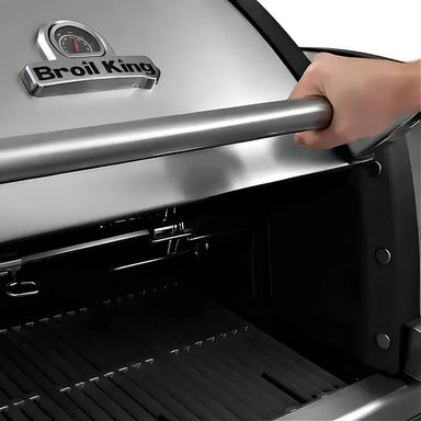 Close-up of the stainless steel hood handle and built-in Accu-Temp thermometer on a Broil King Imperial S 690i gas grill.