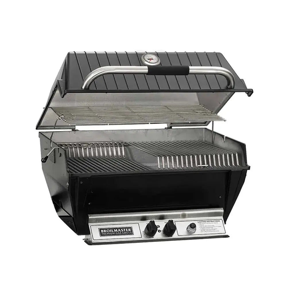 Broilmaster Premium Gas Grill head unit open, showing the deep cast aluminum body, stainless steel grates, and front control panel