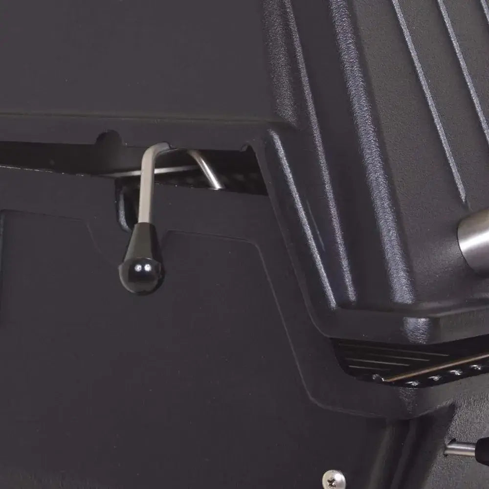 Close-up of the black hood control lever on the side of the Broilmaster grill for regulating heat and airflow