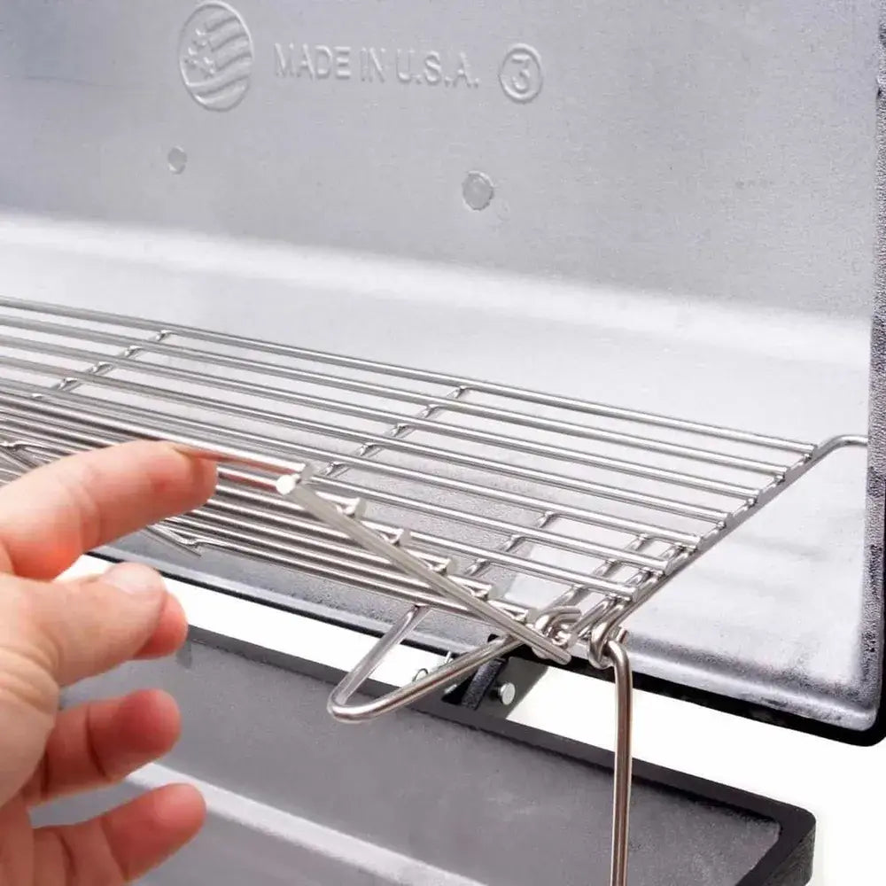 Adjustable upper warming rack inside the Broilmaster grill, demonstrating easy access and sturdy hinge design
