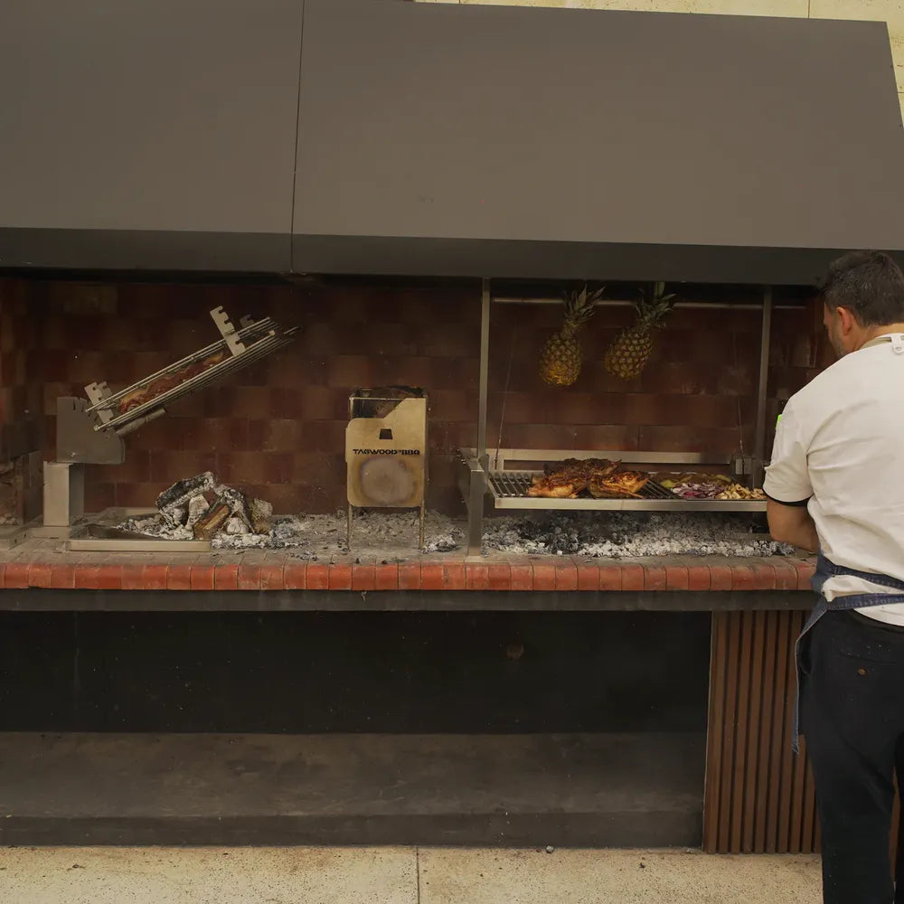 Tagwood BBQ09SS Santa Maria insert grill installed in masonry barbecue pit with rotisserie and grill system