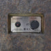 Close-up of the Elementi fire table control panel showing the electronic ignition button and flame adjustment knob.