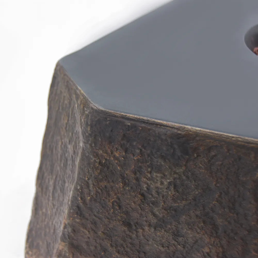 Detail shot of the Glass Fiber Reinforced Concrete (GFRC) material showing the high-fidelity natural rock texture and smooth table surface.