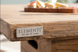 Detail of the Elementi logo plate on the gray concrete base of the Rova Fire Bar Table 40k BTU.