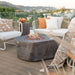 Elementi Columbia OFG105 41.7-inch gas fire table made of dark grey GFRC with a realistic faux-stone finish and lava rock infill.