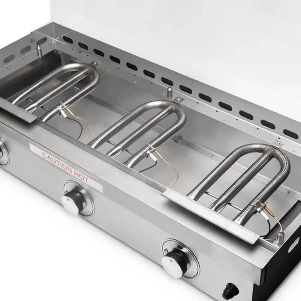 Close-up of stainless steel U-shaped burners inside a gas griddle for even heat distribution