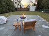 Outdoor living space with a slate patio and a functioning TessaRai 360 fire water bowl as a focal point.