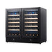 Angled view of KingsBottle KBU190W2 black glass dual zone wine cooler fully stocked with wine bottles on hardwood shelves.