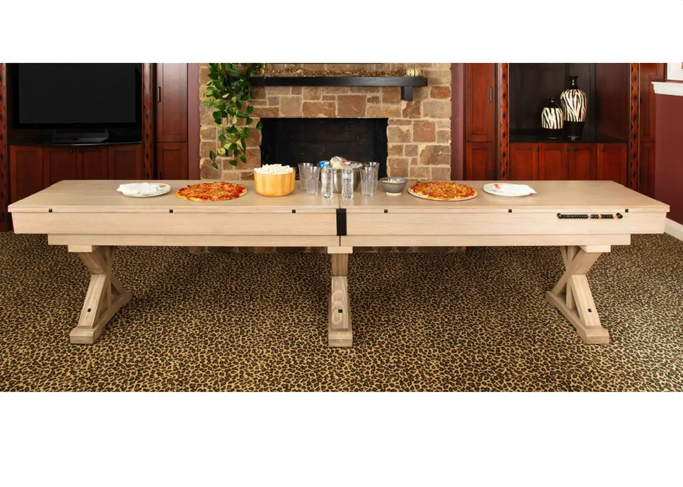 Freetime Fun Rockford Rustic Oak 14-foot shuffleboard table converted into a dining buffet table with food in a rustic game room.