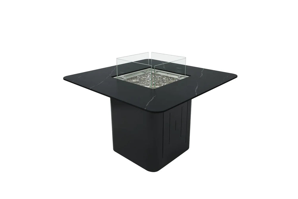 Angled View of Elementi Plus OFP202BB Brugge Bulgaria Black fire dining table shown next to its matching dark porcelain propane tank cover for a cohesive outdoor patio design.