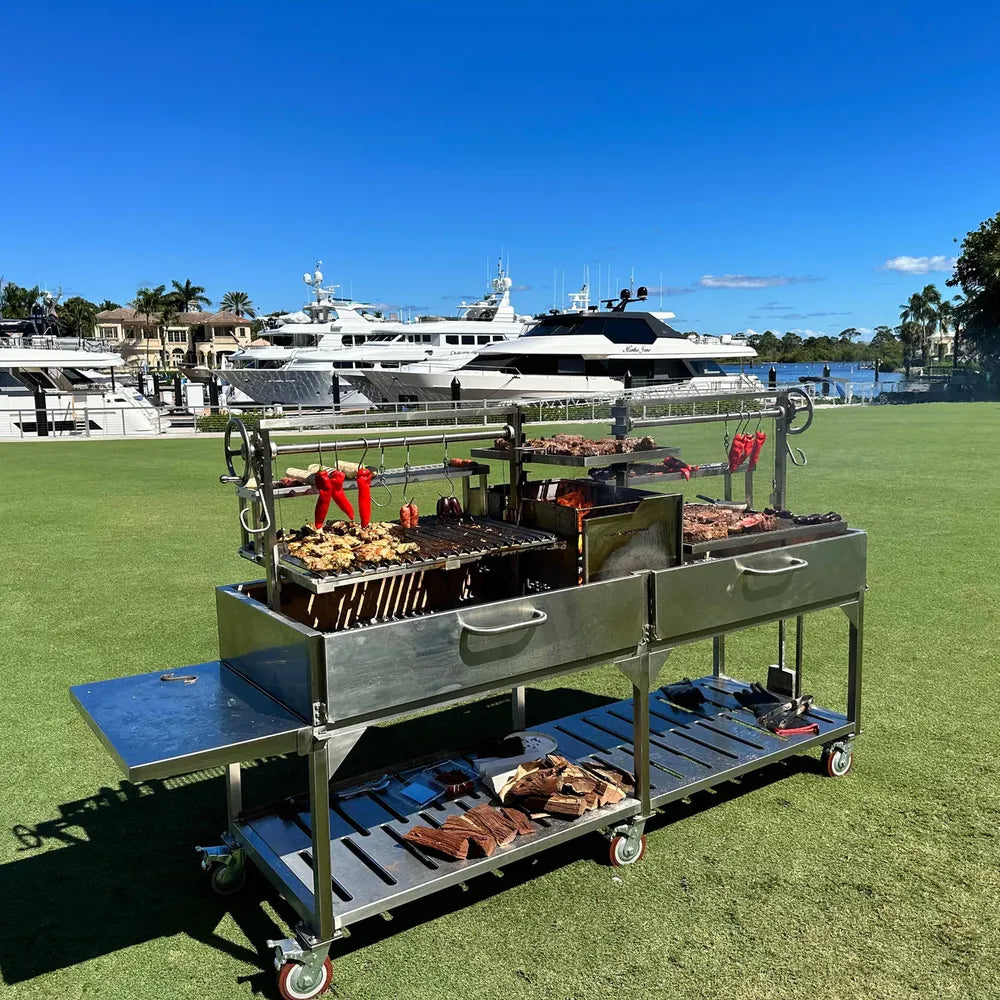 Tagwood BBQ24SS Double Santa Maria grill side view with adjustable crank lift and stainless prep shelf