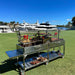 Tagwood BBQ24SS Double Santa Maria grill side view with adjustable crank lift and stainless prep shelf